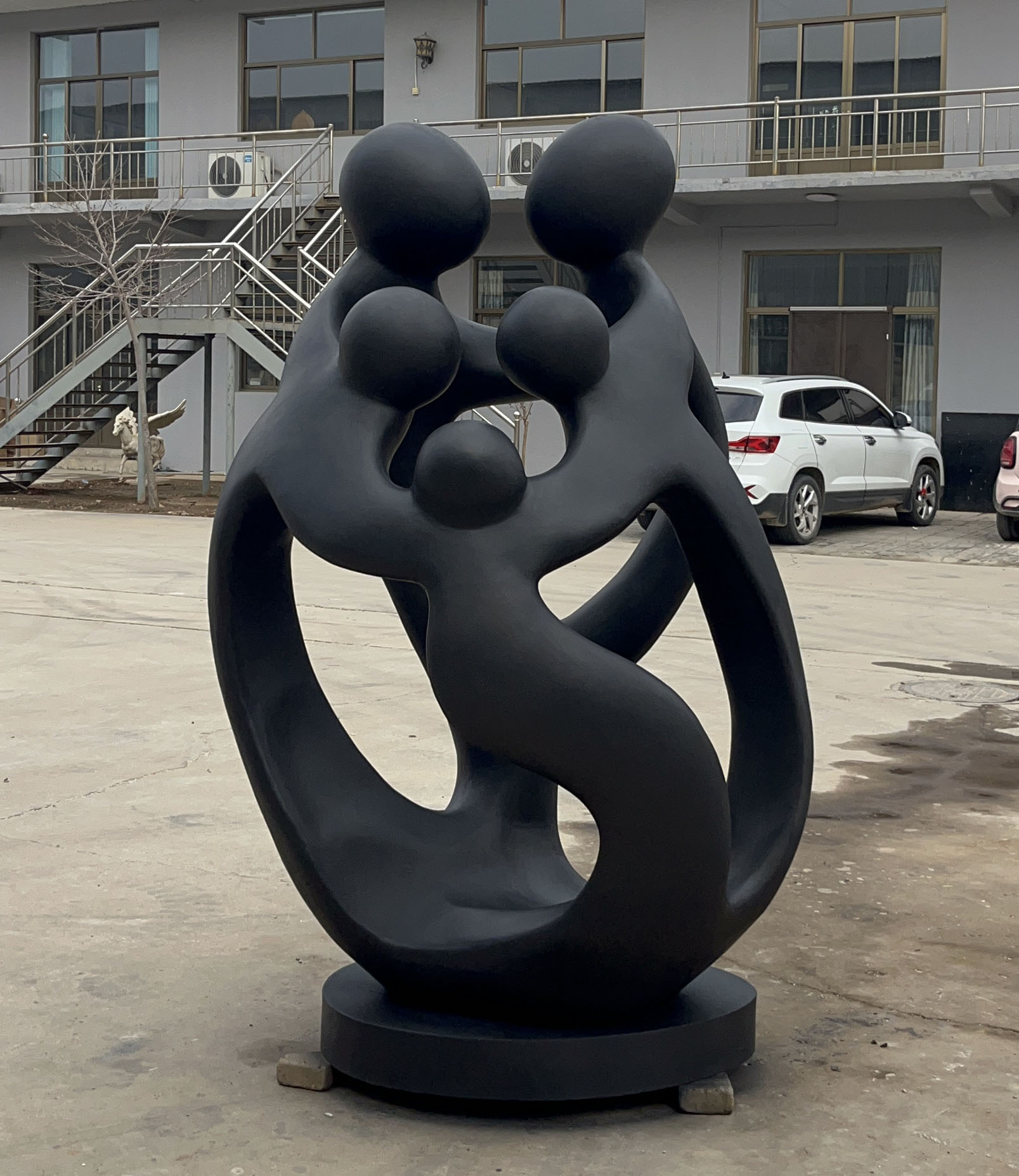 Abstract sculpture of figures celebrating a gathering