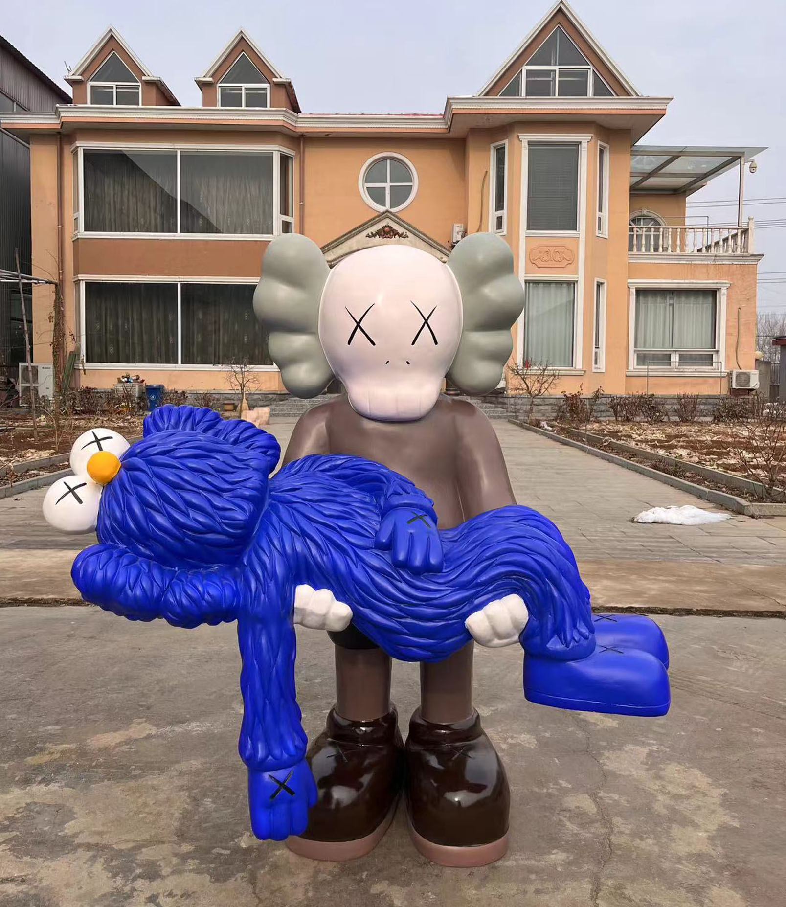 KAWS holding his BFF (partner).